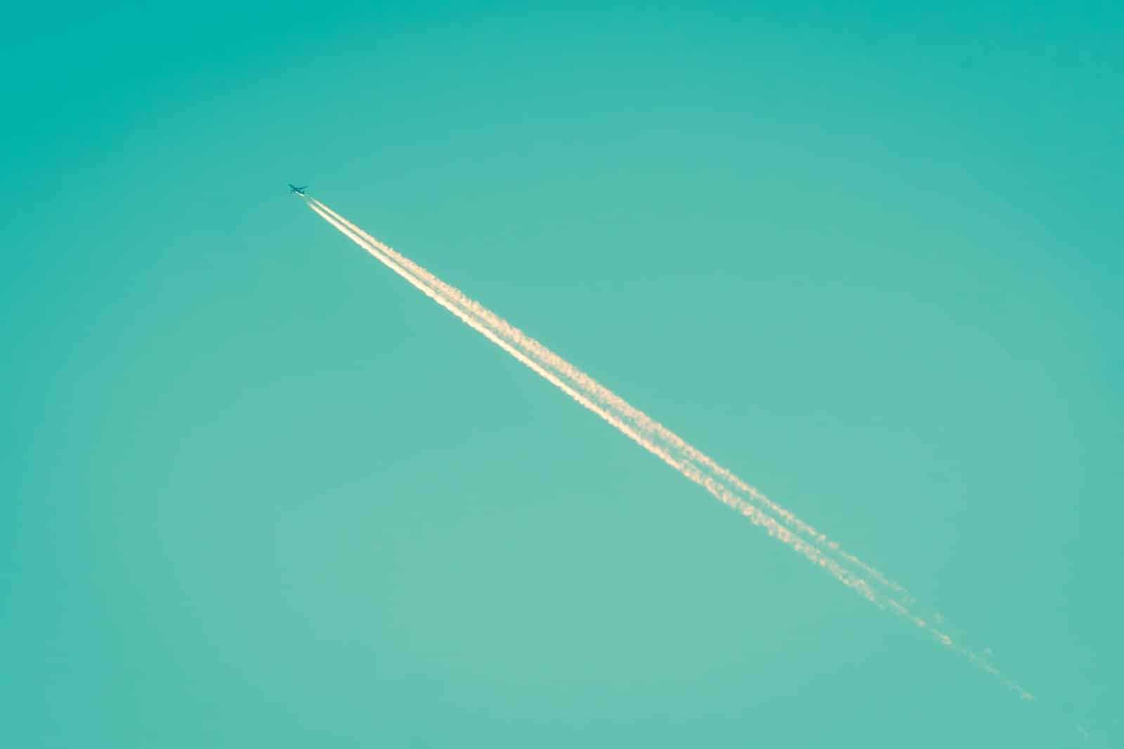 Airplane flying through the sky, representing Hajj travel from USA and Canada